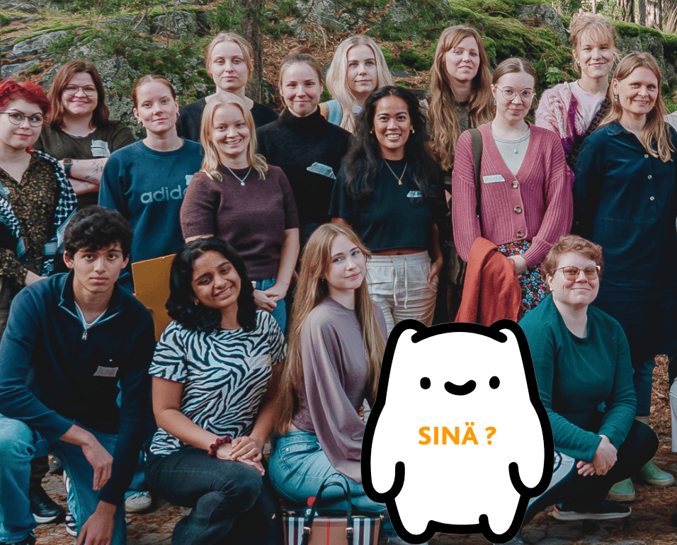 16 hymyilevää nuorta aikuista ryhmäkuvassa kolmessa rivissä. Eturivi on kyykyssä ja heidän edessään on valkoinen piirroshahmo jonka päällä lukee sinä ja kysymysmerkki.